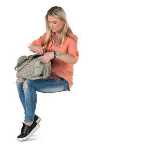 woman sitting and opening her handbag