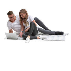 couple lying on the blanket and watching videos.