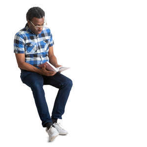 black man sitting and reading a book