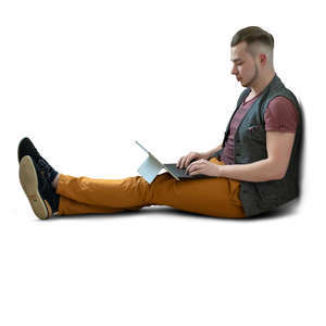 man sitting on the floor and working on a tablet