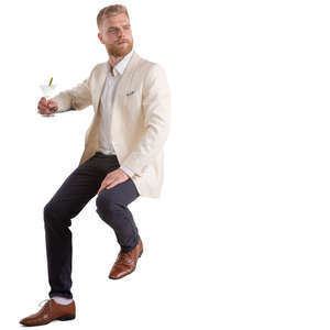 man drinking martini at a bar