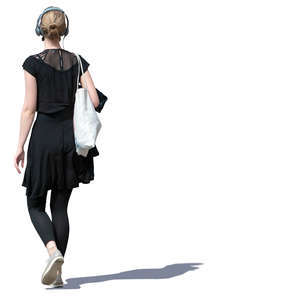 young woman with headphones walking