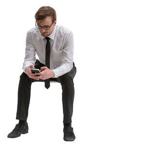 cut out businessman sitting and browsing his phone