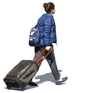 woman walking and pulling a suitcase
