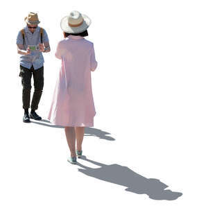 cut out backlit man taking a picture of a woman in a pink dress