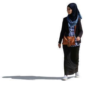 young smiling muslim woman walking on a sunny day