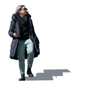 cut out woman in a winter overcoat walking down the stairs