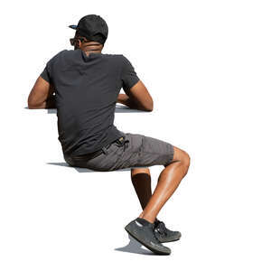 cut out black man sitting outside in the sunlight