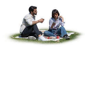 two people sitting in the park on the grass and drinking coffee