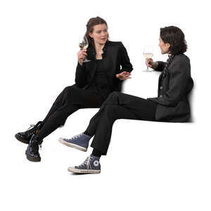 two women sitting and drinking wine and talking