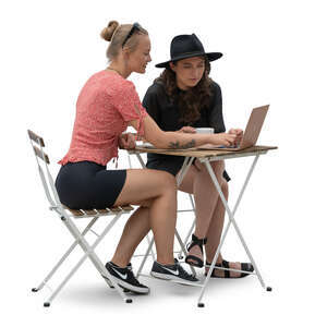 two young women sitting nad looking at a laptop