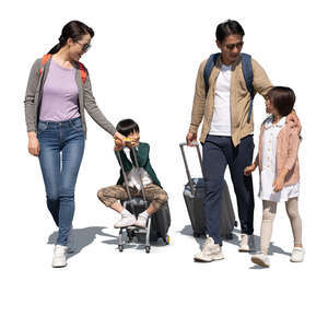 asian family with travelling suitcases walking