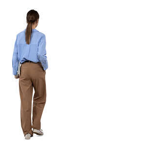 woman with a laptop under her arm walking