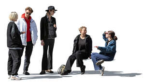 group of young people standing and sitting