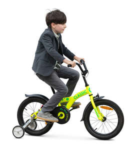 boy riding a bike with training wheels