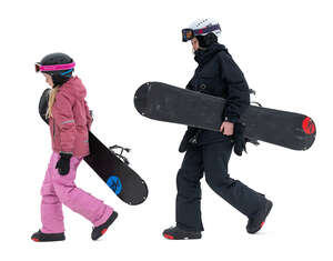 two girls with snowboards walking