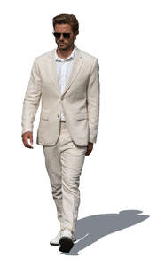 cut out man in a white suit walking