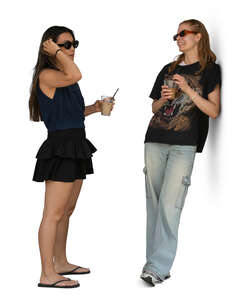 woman leaning against the walk and talking to a girlfriend