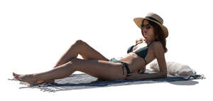 cut out woman with a hat sunbathing on the beach
