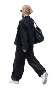 cut out woman in casual black outfit walking and talking on the phone