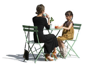 cut out japanese woman and her daughter sitting in a street cafe