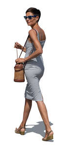 woman in a striped dress walking and looking back over her shoulder