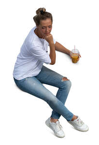 top view of a woman sitting and drinking smoothie