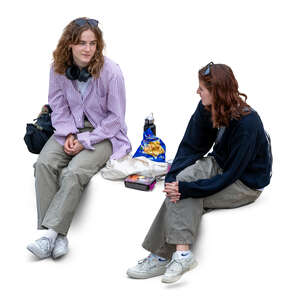 two cut out women sitting and eating seen from above