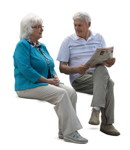 cut out elderly couple sitting and reading a newspaper