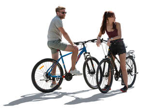 backlit man and woman with bikes stopping and looking around