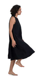 woman in a black dress walking up the stairs at home barefoot