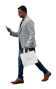indian businessman with a shopping bag and phone walking