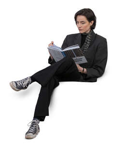 woman sitting on a sofa and reading a book