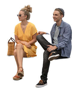 two cut out people sitting on a bench