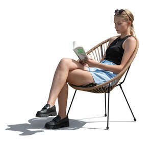 woman sitting in an armchair and reading