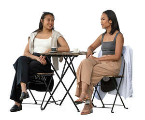 two young asian women sitting in a cafe