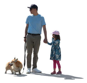 father and daughter with a dog standing in backlight