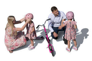 top view of parents helping kids with scooters