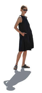 cut out backlit woman in a black dress standing