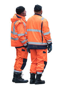 two workers standing and looking at smth