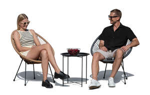 man and woman sitting on a patio in sunlight