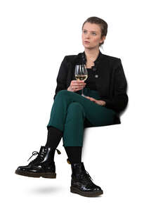 woman sitting on a sofa and drinking wine