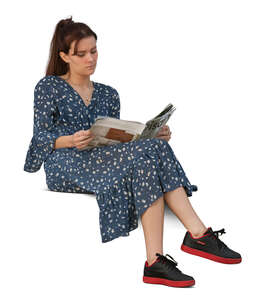 cut out woman sitting on a sofa and reading a magazine