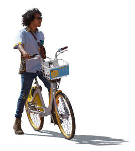 backlit latino man with a bike standing