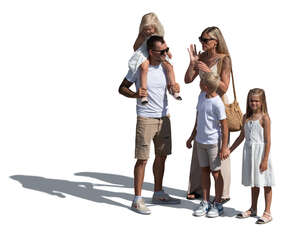 family with three children standing in the street in summer