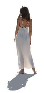 backlit woman in a white dress standing barefoot