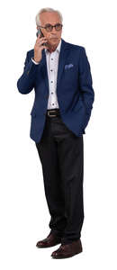 older businessman in a suit standing and talking on a phone