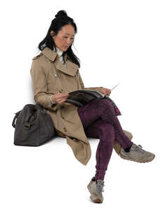 cut out asian woman sitting in autumn