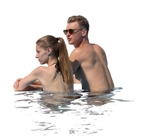 man and woman looking over a pool edge