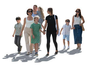 backlit group of adults and kids walking